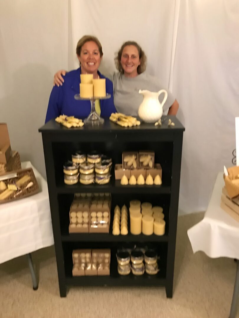 Women posing with homemade candle display