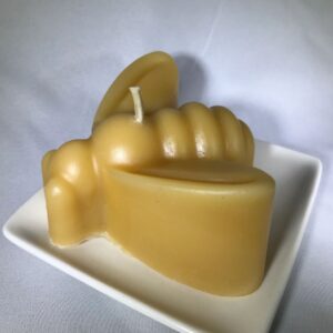 Hand-shaped candle on a dish