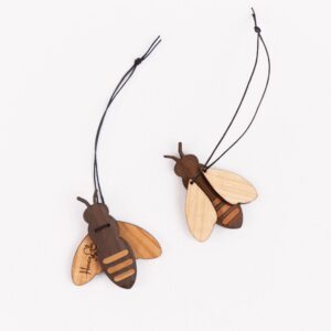 Two wooden bee-shaped ornaments