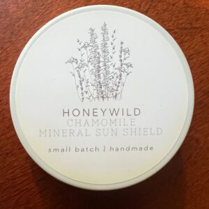Chamomile sun shield container on table