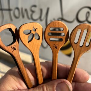 Intricately carved wooden utensils for use as a honey dipper