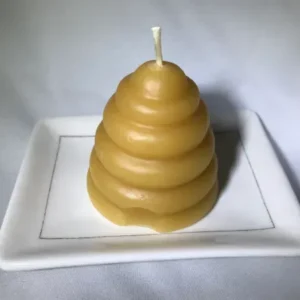 Honeycomb-shaped candle on a plate