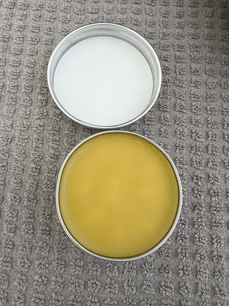 Two tins on textured surface