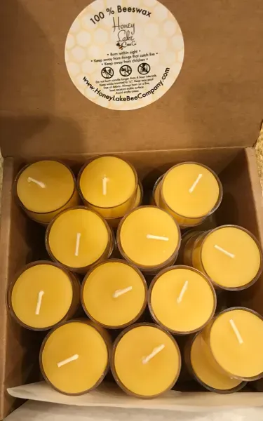 Honey-scented beeswax candles in packaging