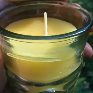 Yellow candle in glass jar