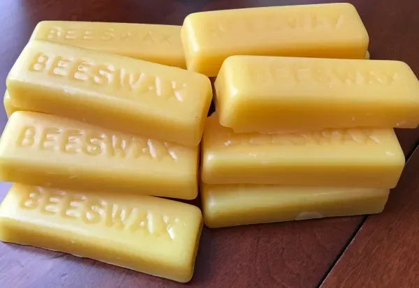 Natural beeswax bricks on wooden surface