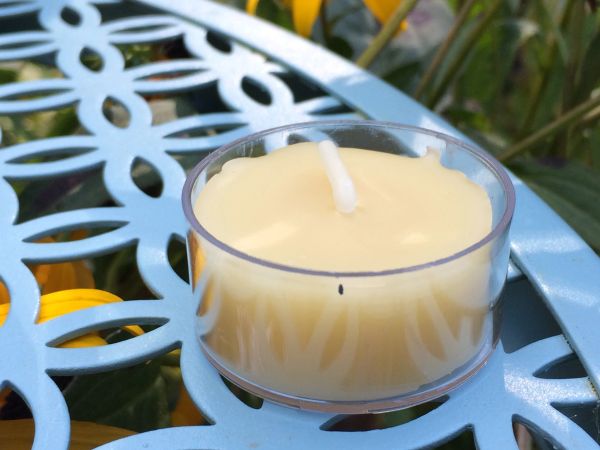 Tea light candle on blue metal table