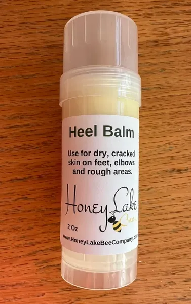 Moisturizing heel balm on wooden surface