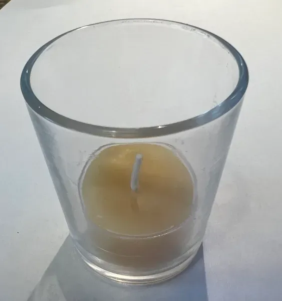 Glass candle holder with yellow candle