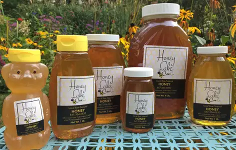 Honey bottles on a floral table