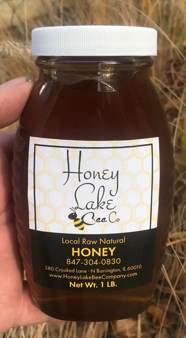 Local raw honey bottle outdoors