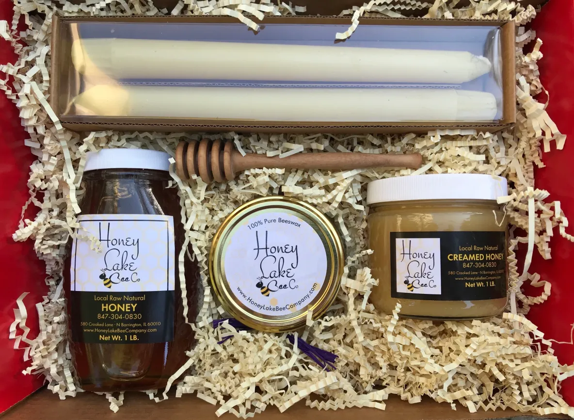 Assorted honey jars and candles in box